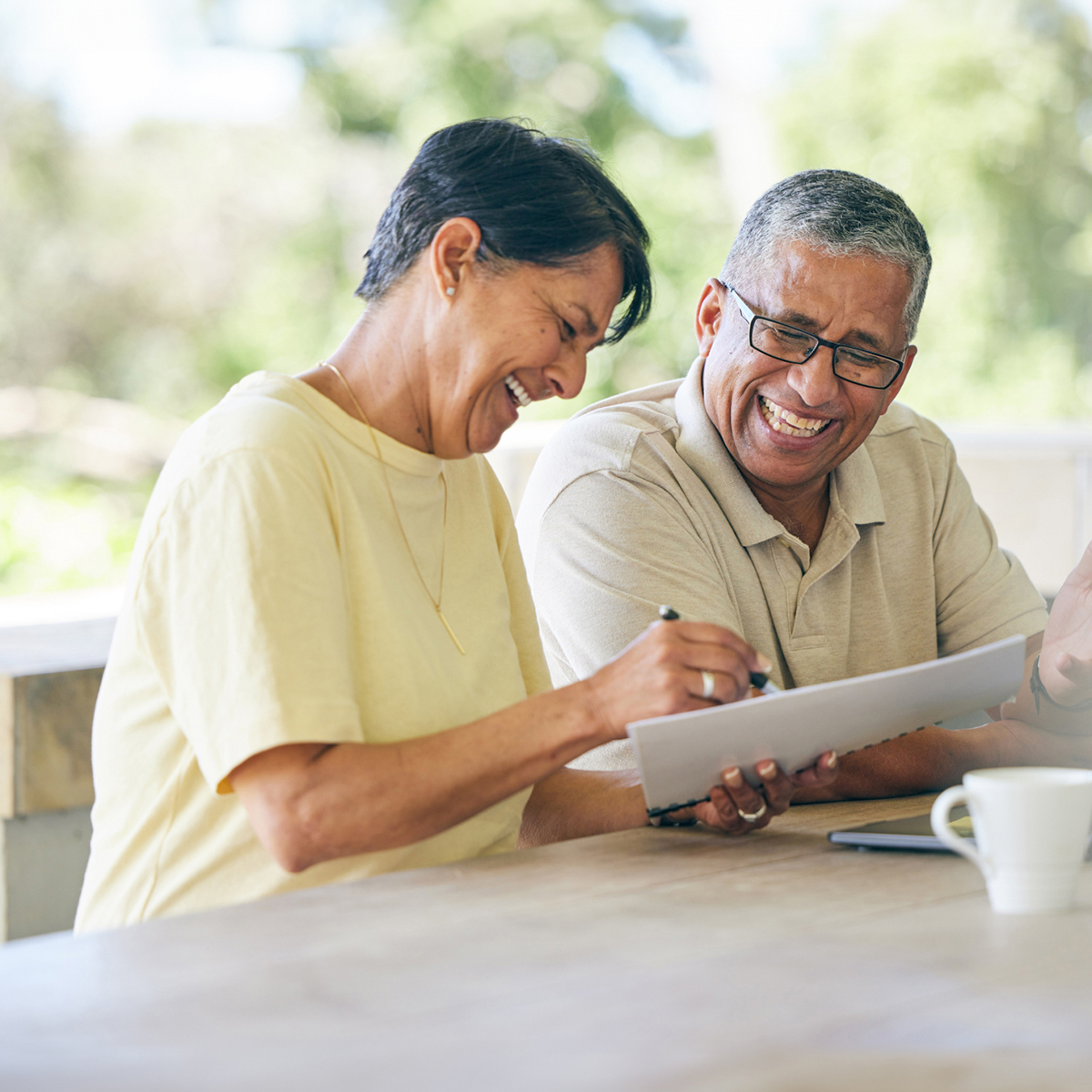 Women filling out paperwork and showing to partner